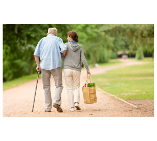 Elderly man walking with caregiver